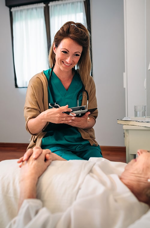 female-doctor-comforting-older-patient