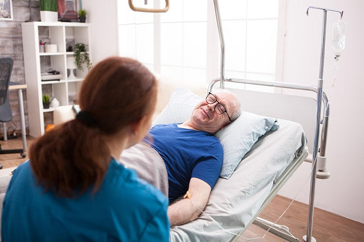 old-man-in-nursing-home-smiling-to-female-doctor